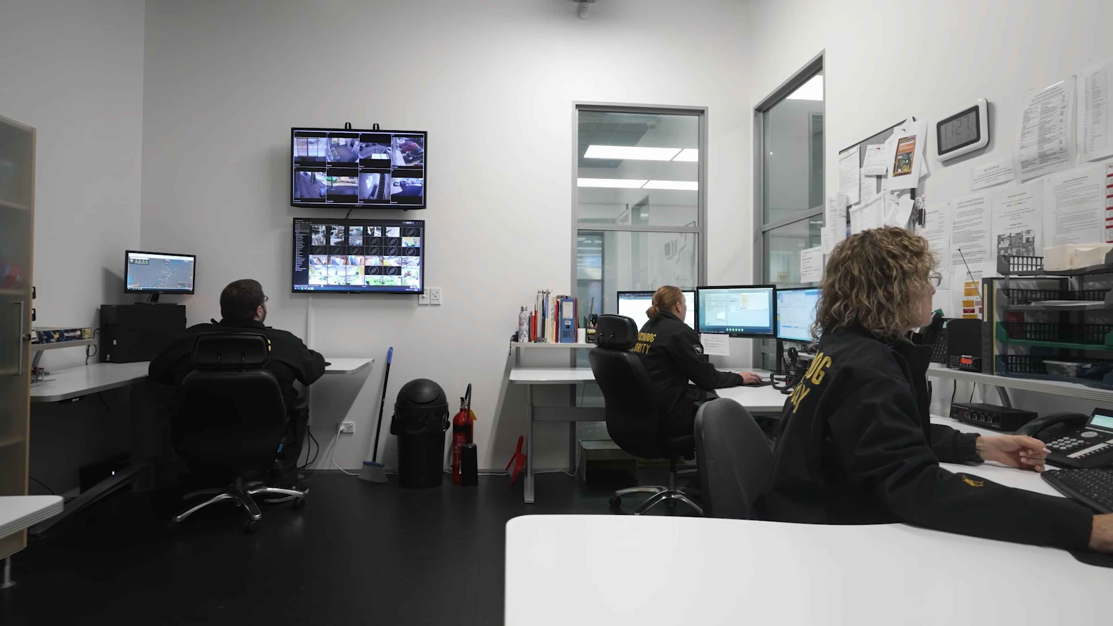 Watchdog monitoring staff reviewing CCTV and alarm events at the Rotorua monitoring centre.